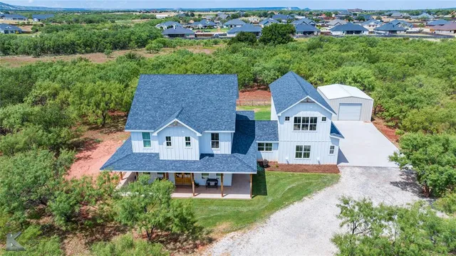 an aerial view of a house with a yard