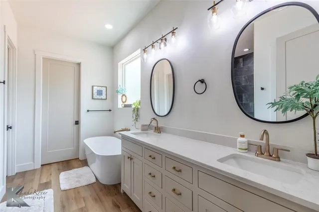 a bathroom with a granite countertop toilet a sink and a mirror