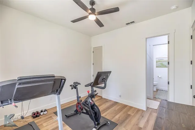 a view of a workspace with furniture and wooden floor
