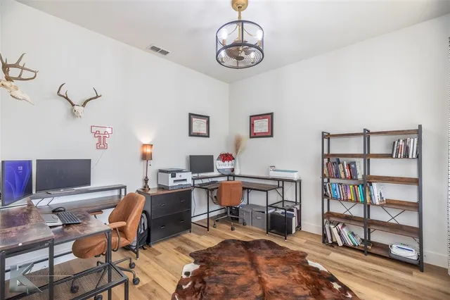 a view of a workspace with a bookshelf