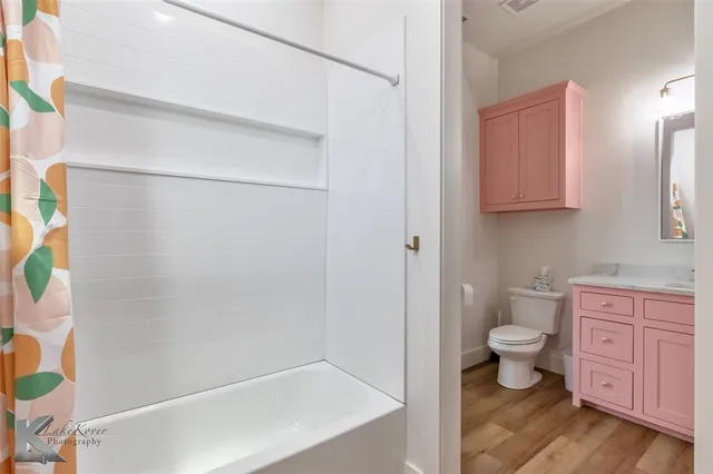 a bathroom with a shower toilet and sink