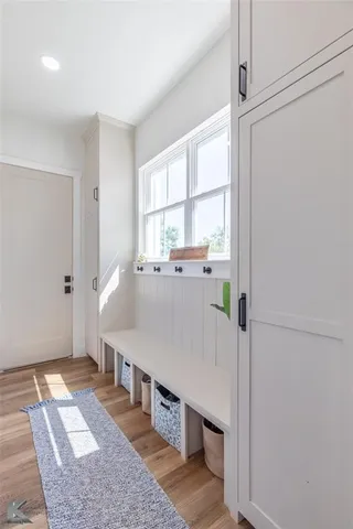 a room with stainless steel appliances kitchen island granite countertop a refrigerator and a sink