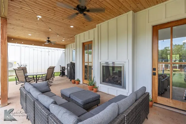 a living room with furniture and large windows