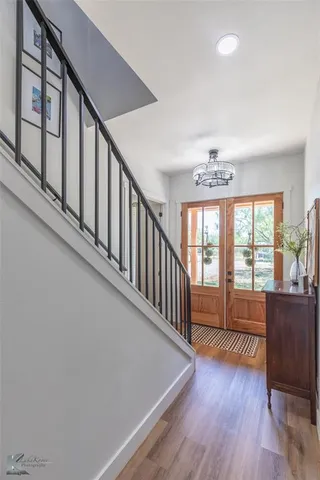 a view of an entryway with wooden floor