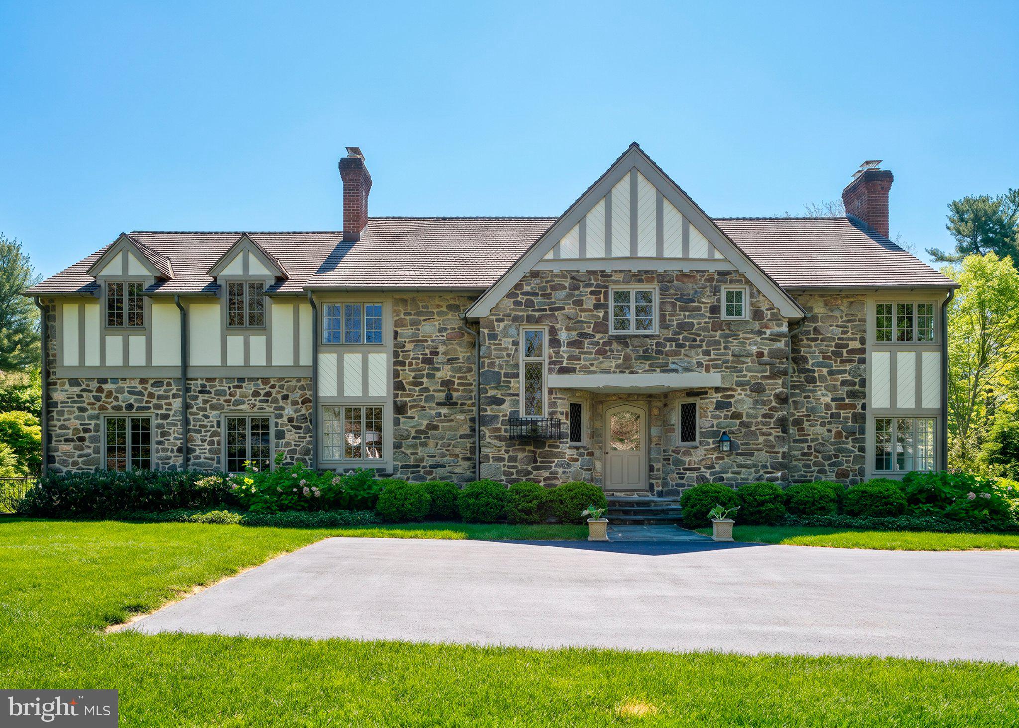 Charming stone Tudor in lush setting.