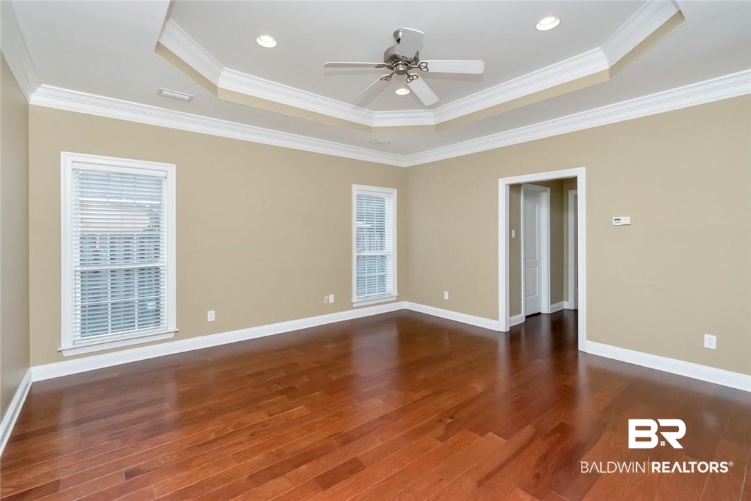 8837 Dawes Lake Road South Mobile, AL 36619 - Photo 17 of 44 Empty room featuring crown molding, ceiling fan, and dark hardwood / wood-style floors