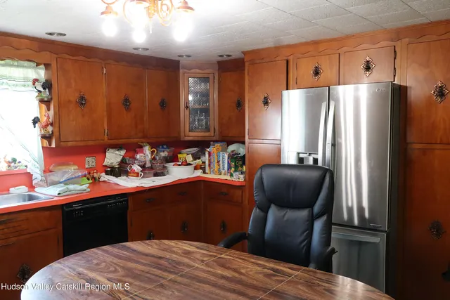 a kitchen with stainless steel appliances a sink stove and refrigerator