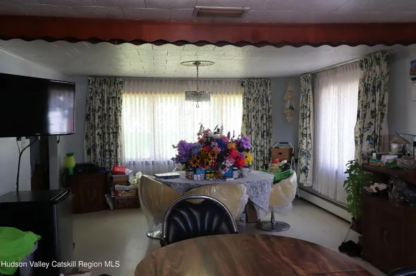 a view of a livingroom with furniture and a window