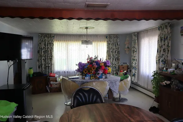 a view of a livingroom with furniture and a window