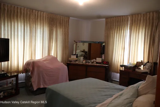 a bedroom with a bed and dresser