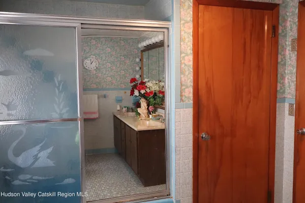 a bathroom with a sink and mirror