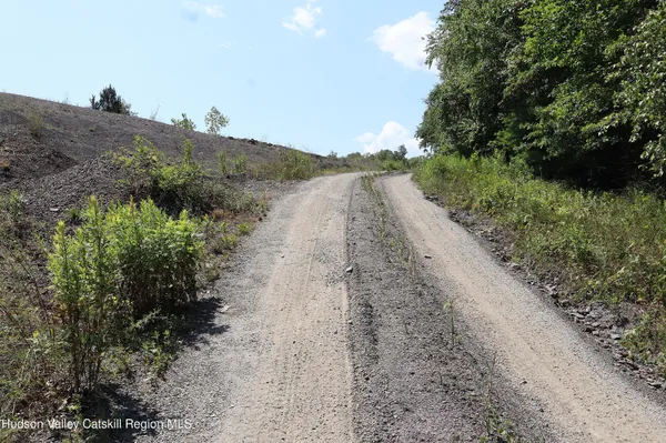 a view of a road with a yard