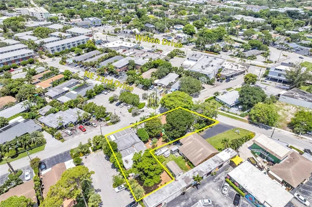 an aerial view of residential houses with open green space