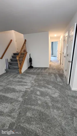 a view of an empty room with stairs