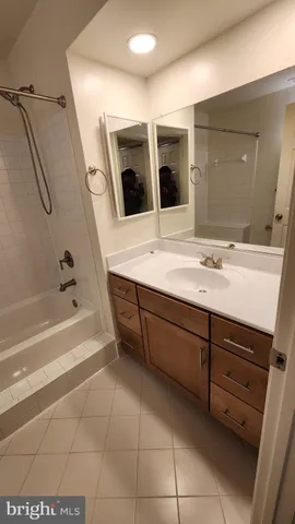 a bathroom with a bath tub with a shower
