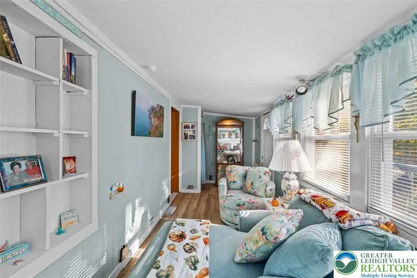 a view of a livingroom with furniture and staircase