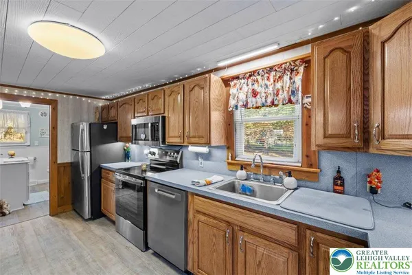 a kitchen that has a sink and a stove top oven