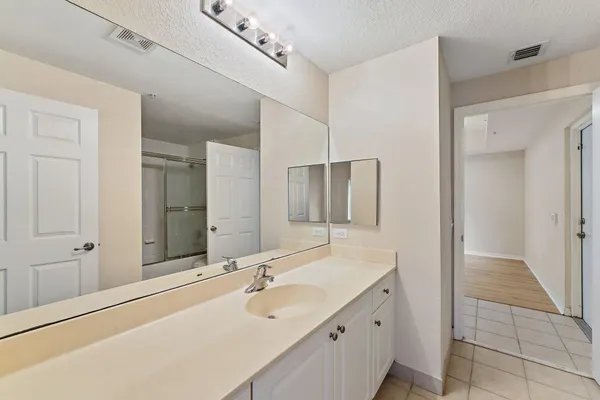 a bathroom with a tub sink and mirror