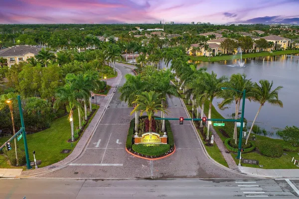 an aerial view of residential houses with outdoor space and swimming pool