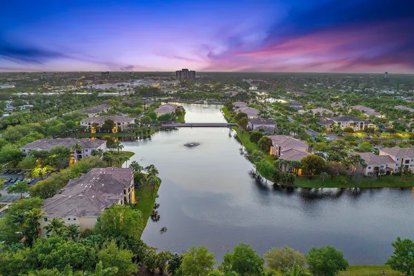an aerial view of residential houses with outdoor space and lake view