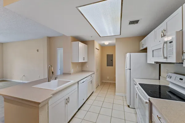 a kitchen with a sink cabinets and refrigerator