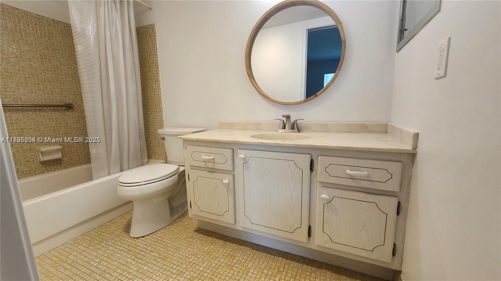 4065 Lyndhurst North, Unit 4065 Deerfield Beach, FL 33442 - Photo 11 of 34 a bathroom with a toilet a sink and mirror