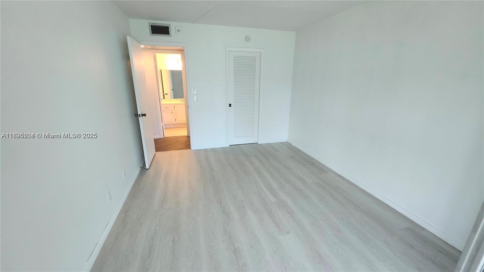 4065 Lyndhurst North, Unit 4065 Deerfield Beach, FL 33442 - Photo 12 of 34 a view of a room with wooden floor and a window