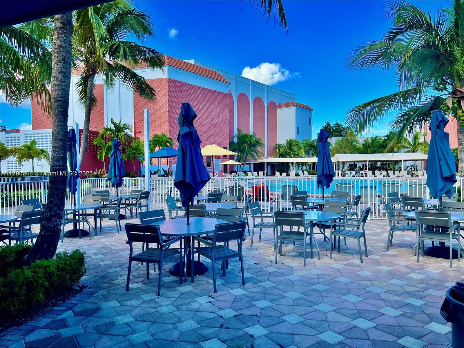 4065 Lyndhurst North, Unit 4065 Deerfield Beach, FL 33442 - Photo 30 of 34 a group of people sitting outside of a building