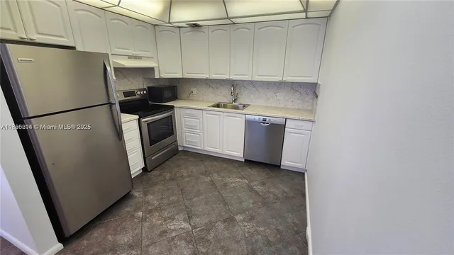 a kitchen with a refrigerator sink stove and cabinets