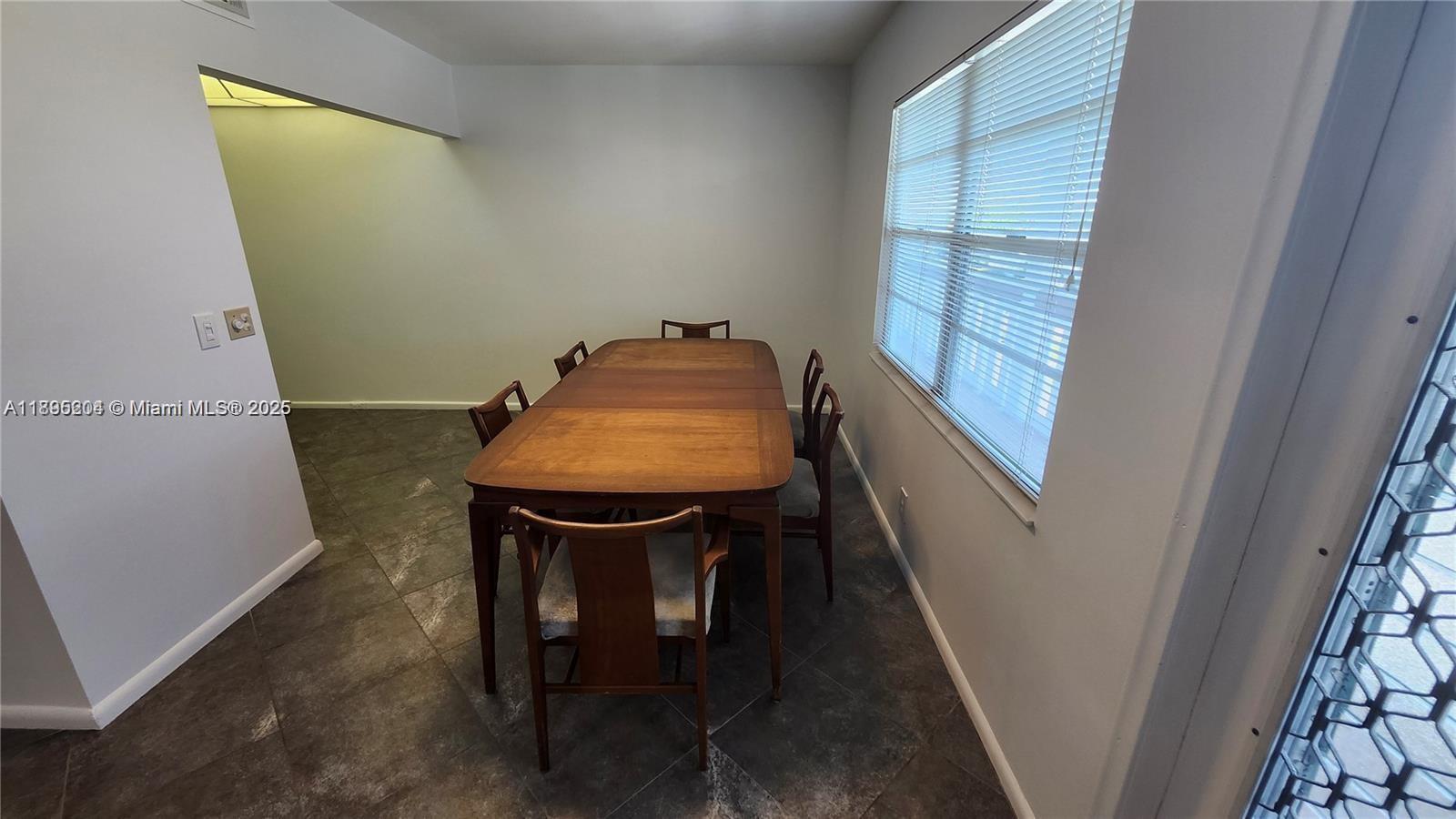 4065 Lyndhurst North, Unit 4065 Deerfield Beach, FL 33442 - Photo 4 of 34 a view of a room with table and chair