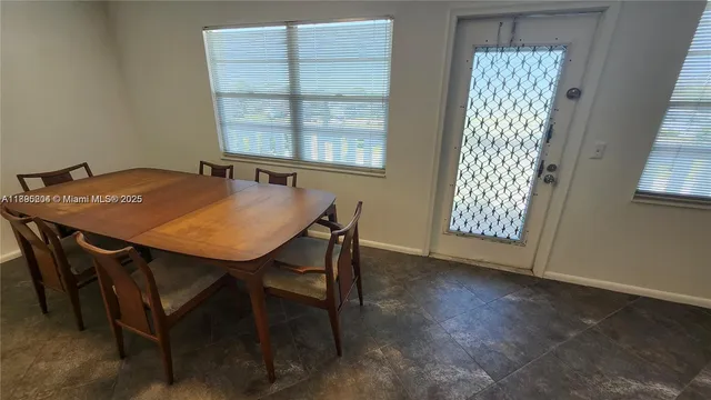 a view of a dining room with furniture and window