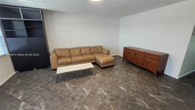 a living room with furniture and a cabinet