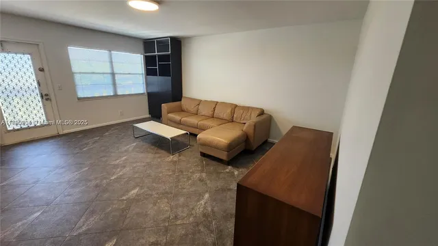 a living room with furniture and window