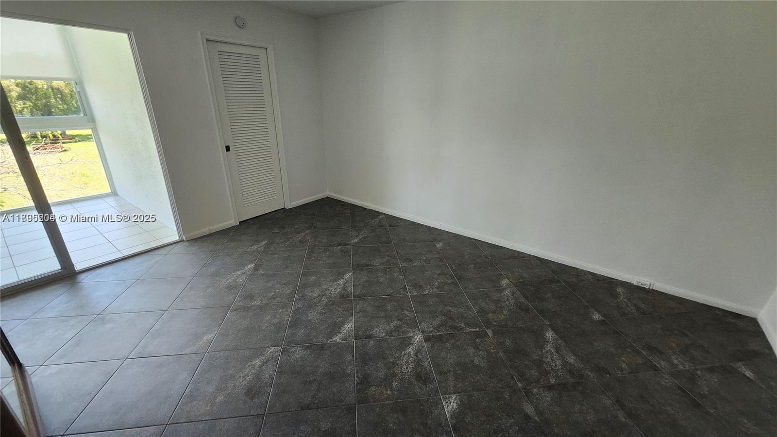 4065 Lyndhurst North, Unit 4065 Deerfield Beach, FL 33442 - Photo 9 of 34 a view of an empty room and window