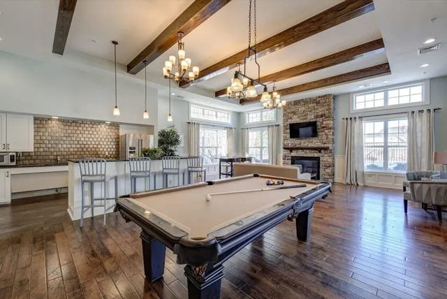 a room with pool table and windows