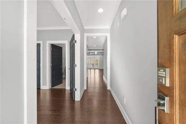 a view of a hallway with wooden floor