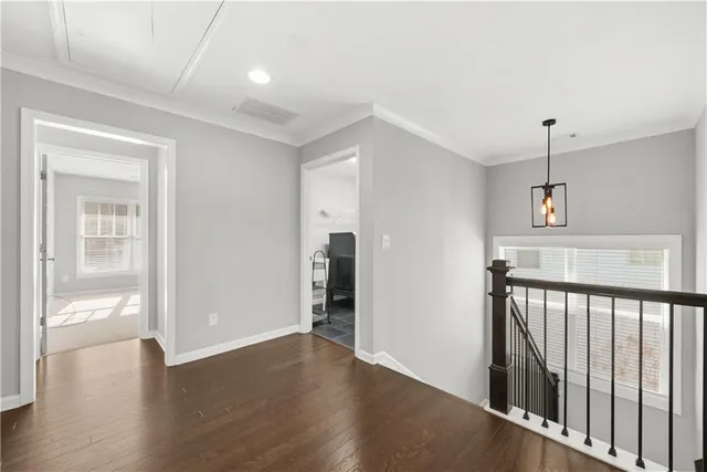 a view of hallway with wooden floor