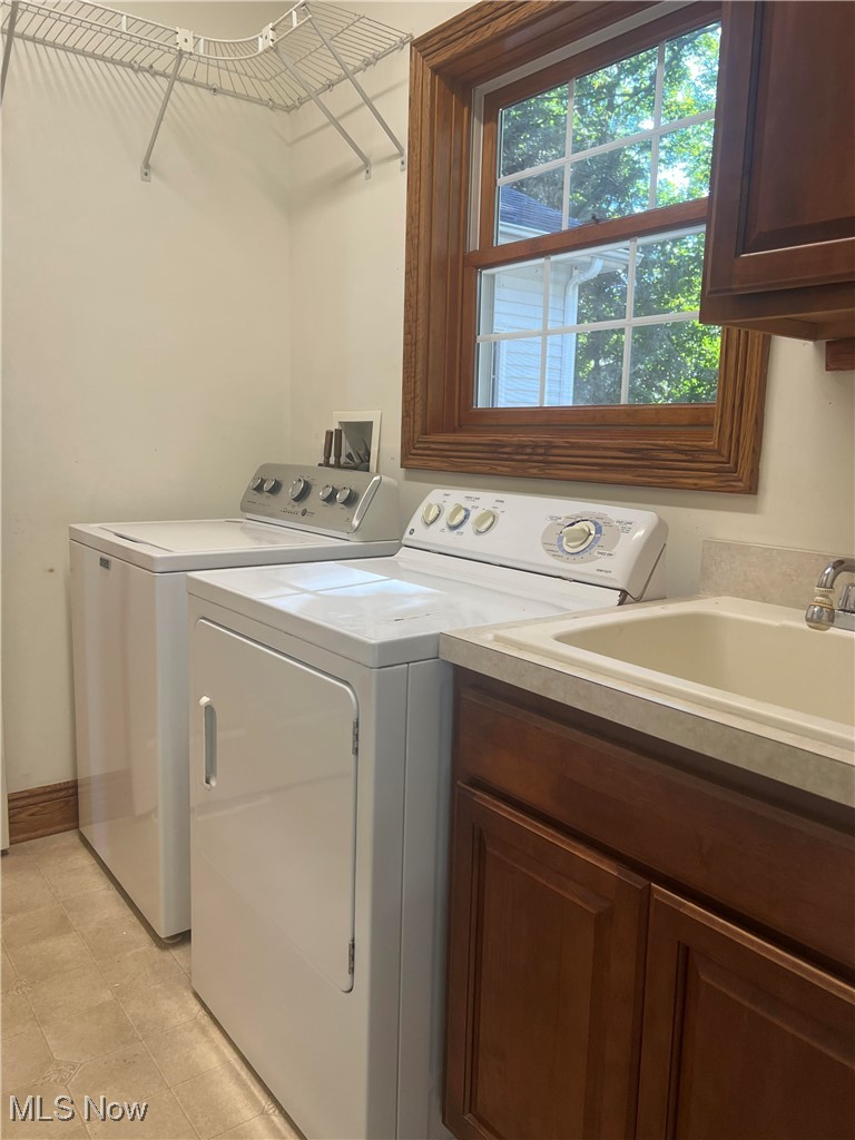 1837 Haines Road Madison, OH 44057 - Photo 15 of 29 Washroom with cabinet space and washer and dryer