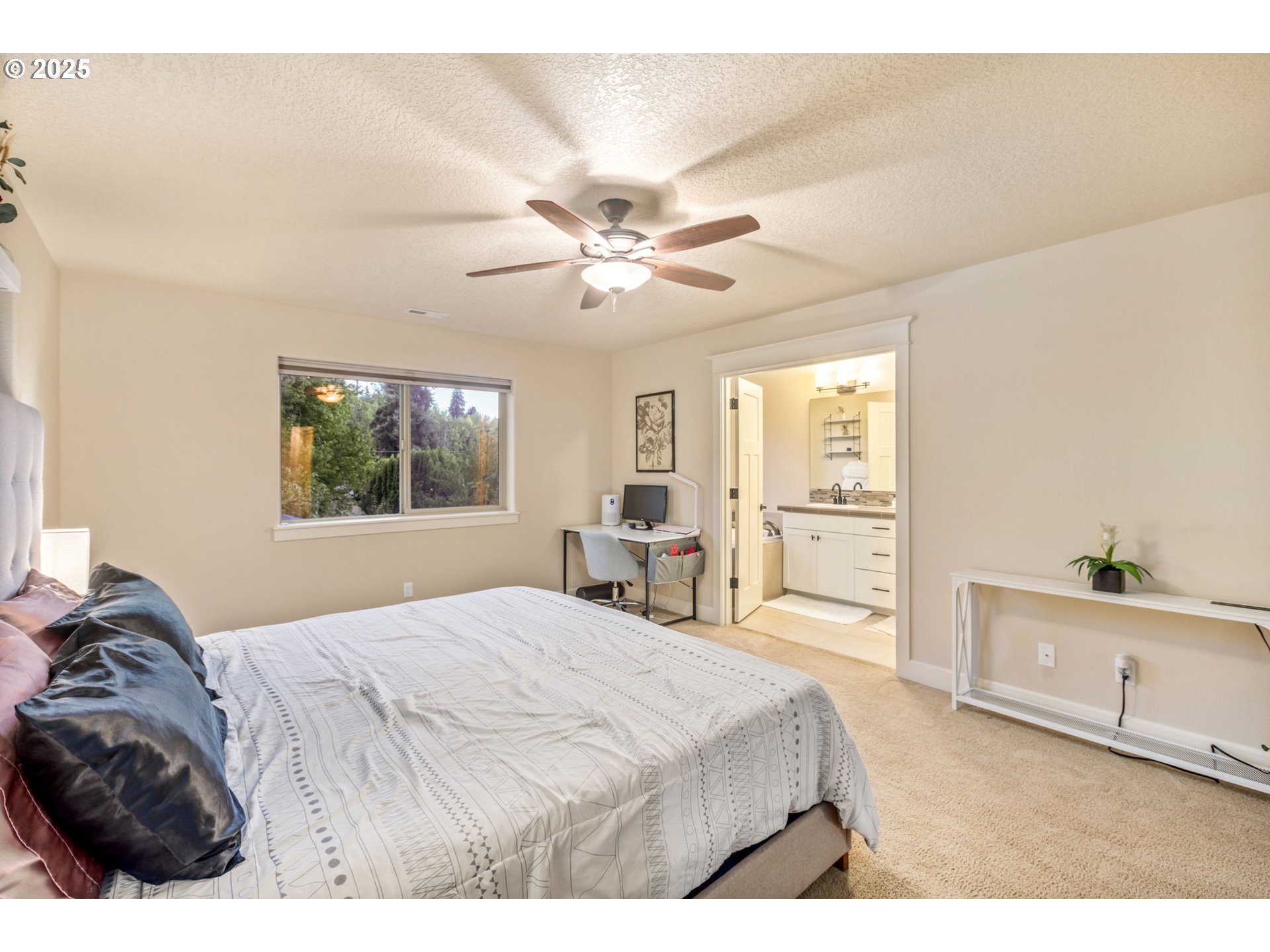 8826 Southwest Spruce Street Portland, OR 97223 - Photo 14 of 34 a bedroom with a bed and a chandelier