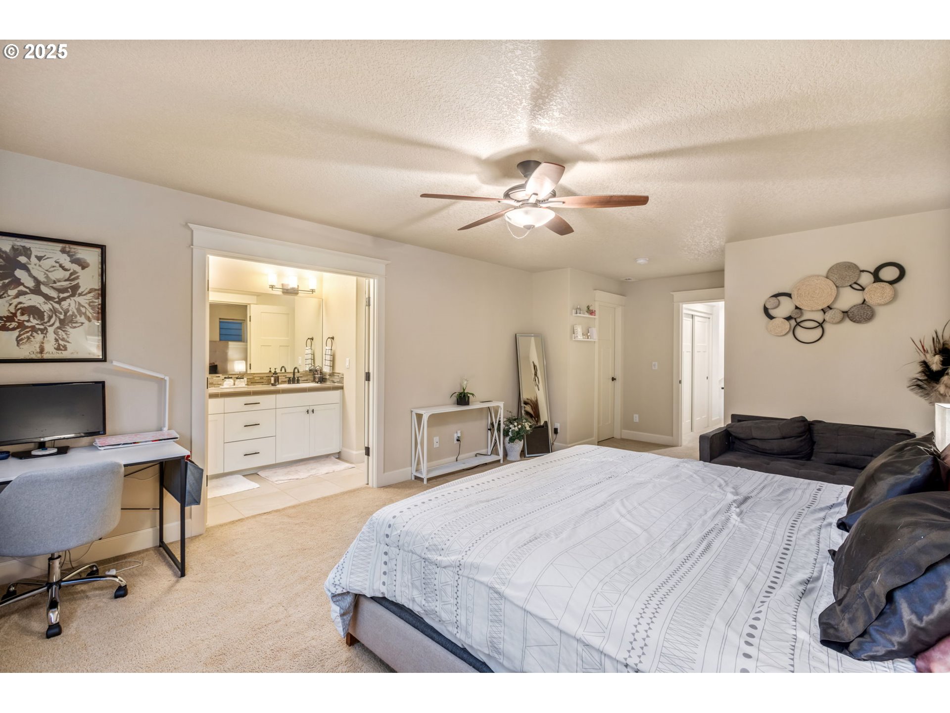 8826 Southwest Spruce Street Portland, OR 97223 - Photo 15 of 34 a spacious bedroom with a bed a desk and chair