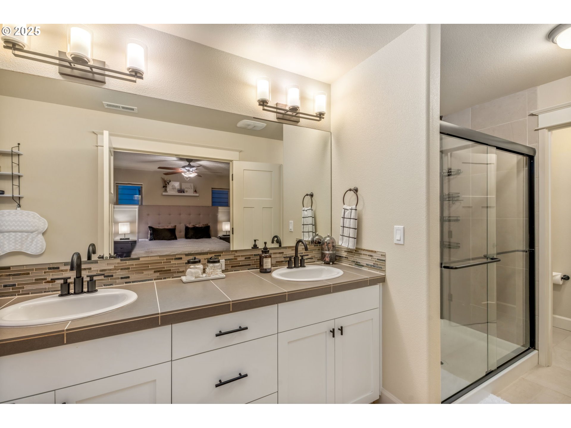 8826 Southwest Spruce Street Portland, OR 97223 - Photo 17 of 34 a bathroom with a sink double vanity and a shower
