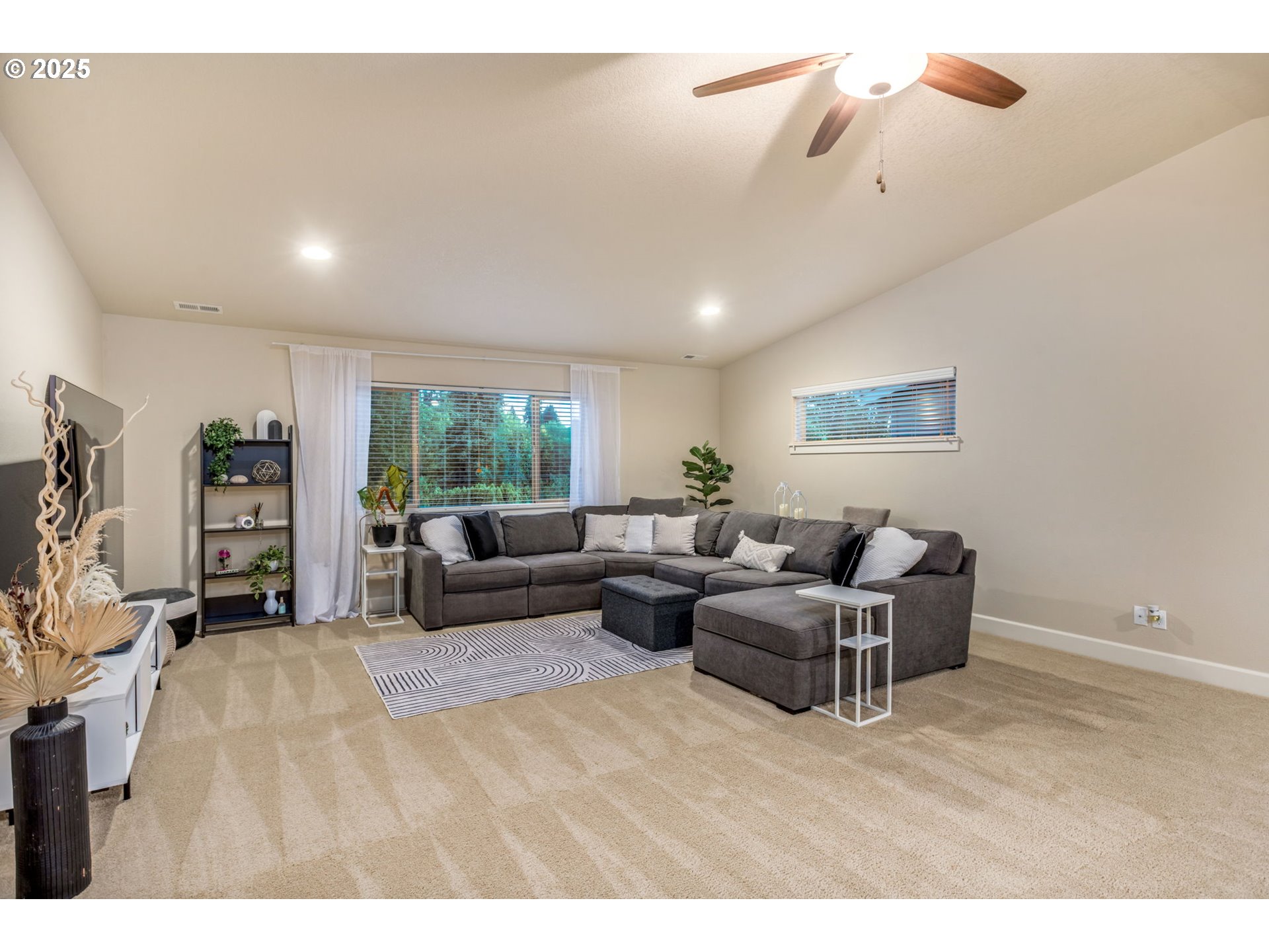 8826 Southwest Spruce Street Portland, OR 97223 - Photo 19 of 34 a living room with furniture a window and a flat screen tv