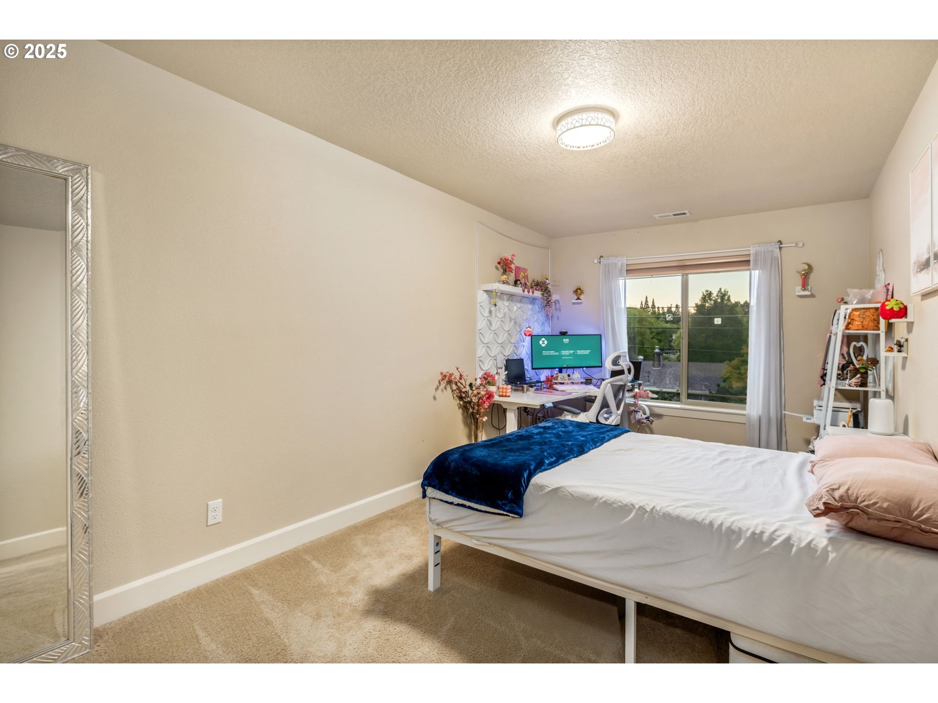 8826 Southwest Spruce Street Portland, OR 97223 - Photo 22 of 34 a bedroom with a bed and large windows