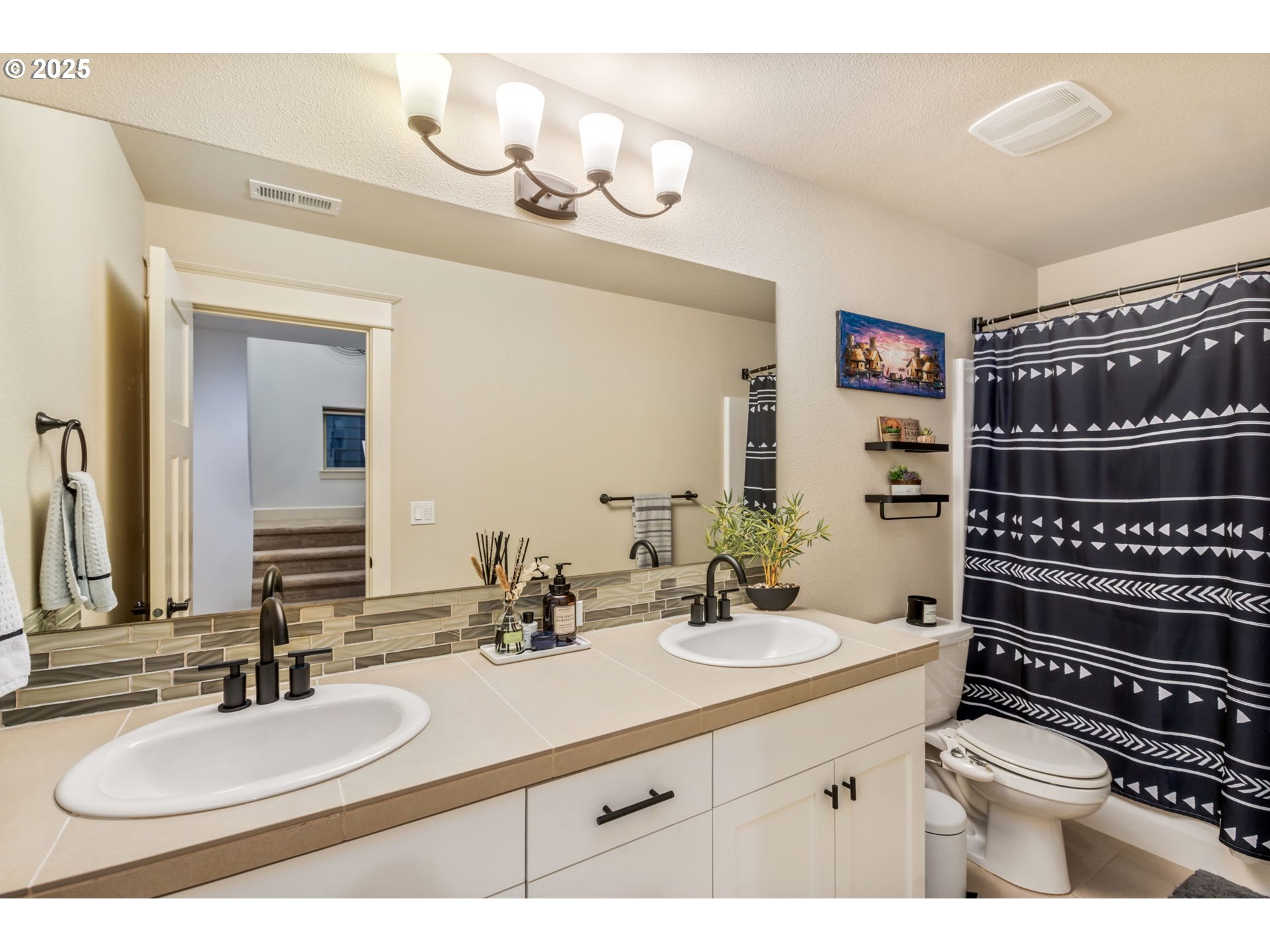8826 Southwest Spruce Street Portland, OR 97223 - Photo 23 of 34 a bathroom with a sink double vanity and a mirror
