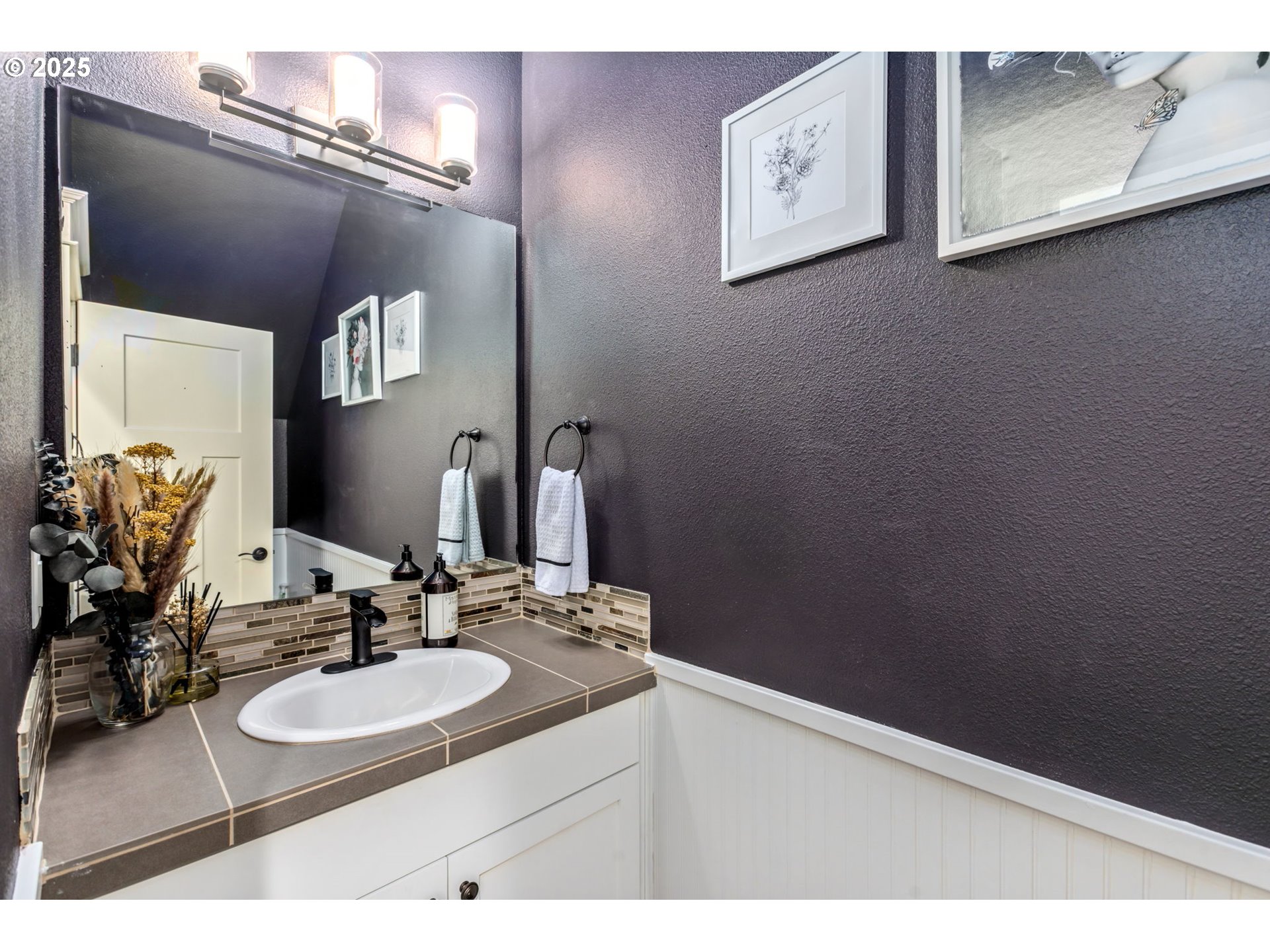 8826 Southwest Spruce Street Portland, OR 97223 - Photo 25 of 34 a bathroom with a sink and a mirror