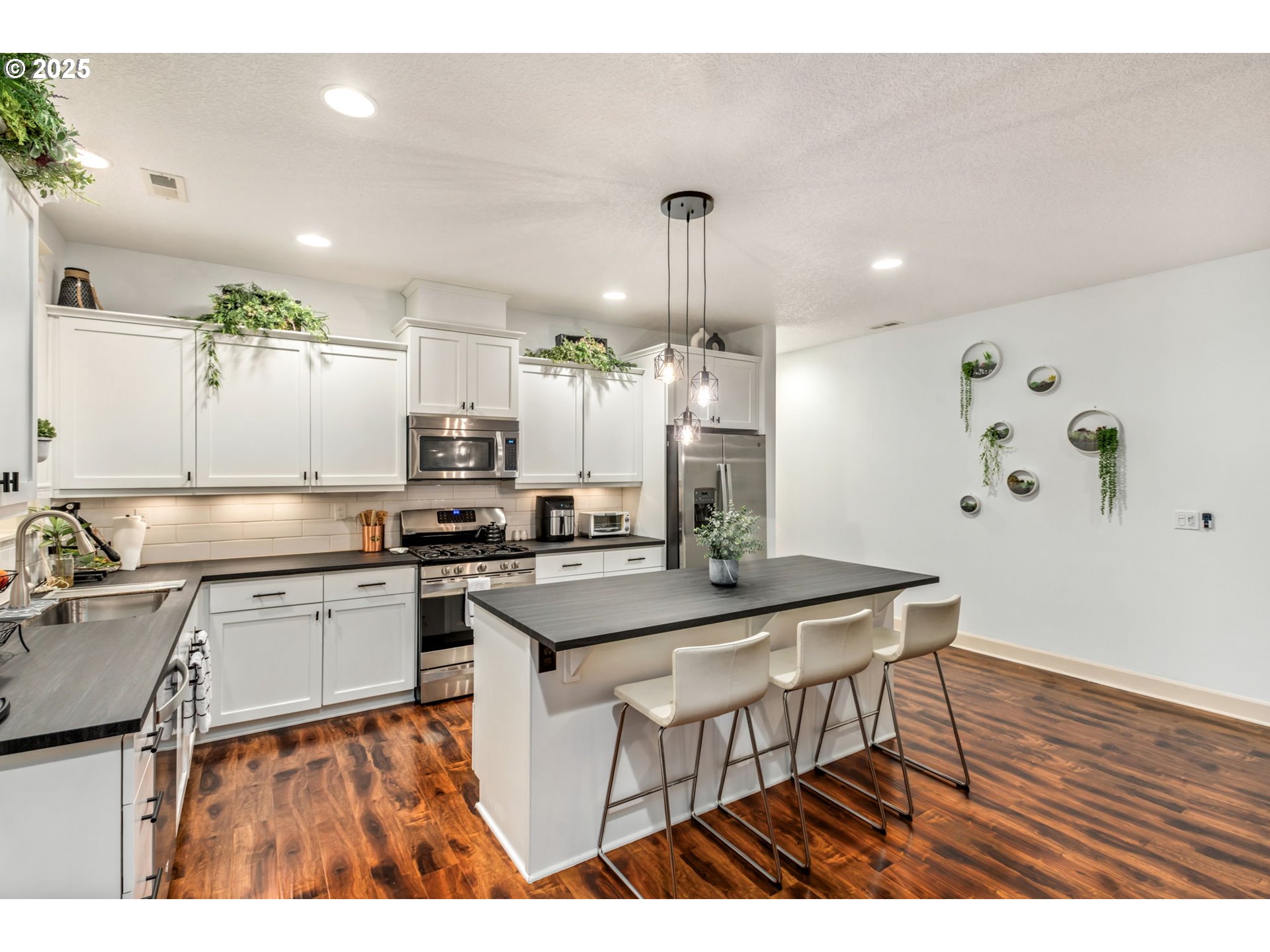 8826 Southwest Spruce Street Portland, OR 97223 - Photo 4 of 34 a kitchen with a sink cabinets and wooden floor