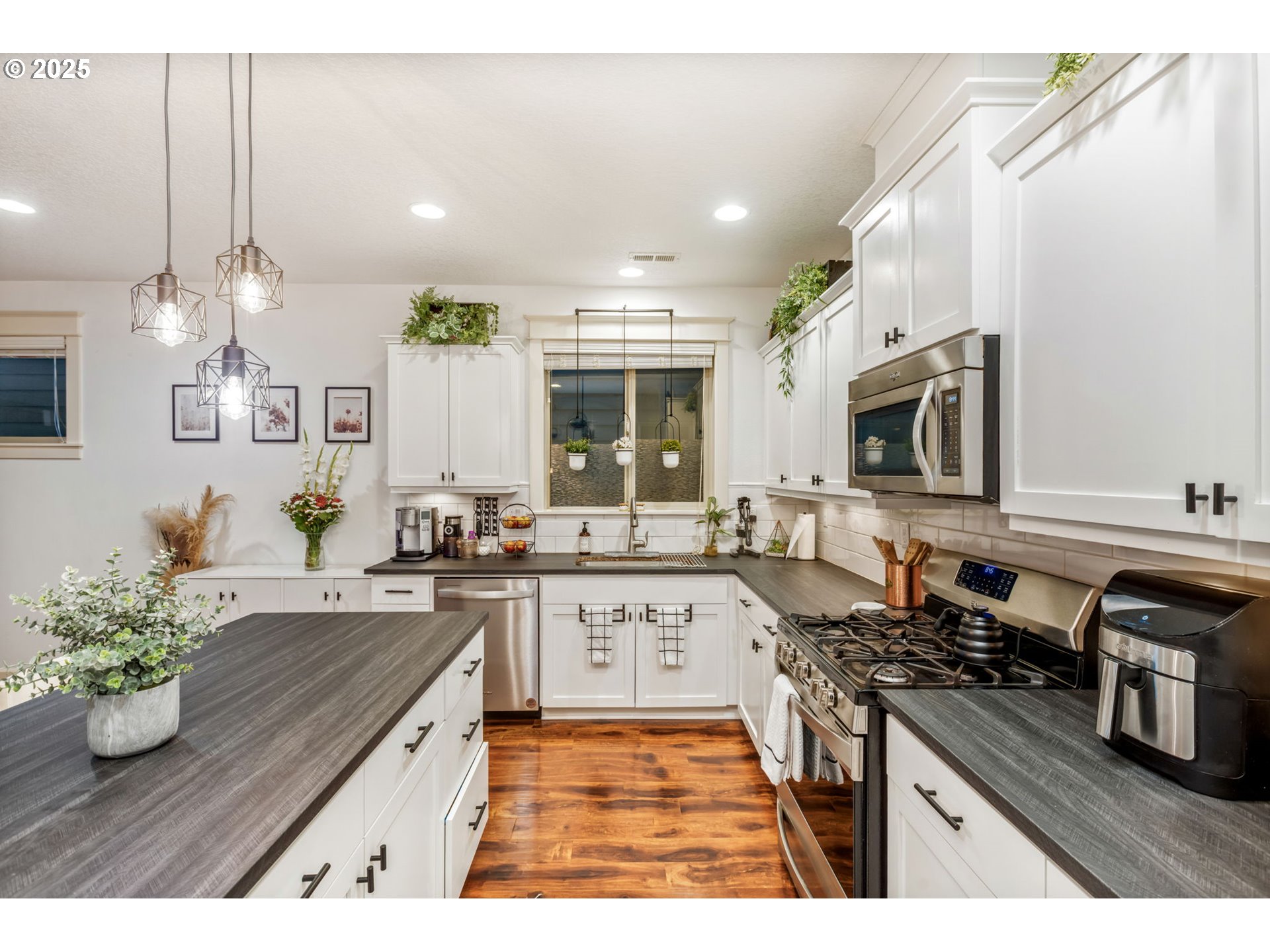 8826 Southwest Spruce Street Portland, OR 97223 - Photo 6 of 34 a kitchen with stainless steel appliances granite countertop a sink stove and cabinets