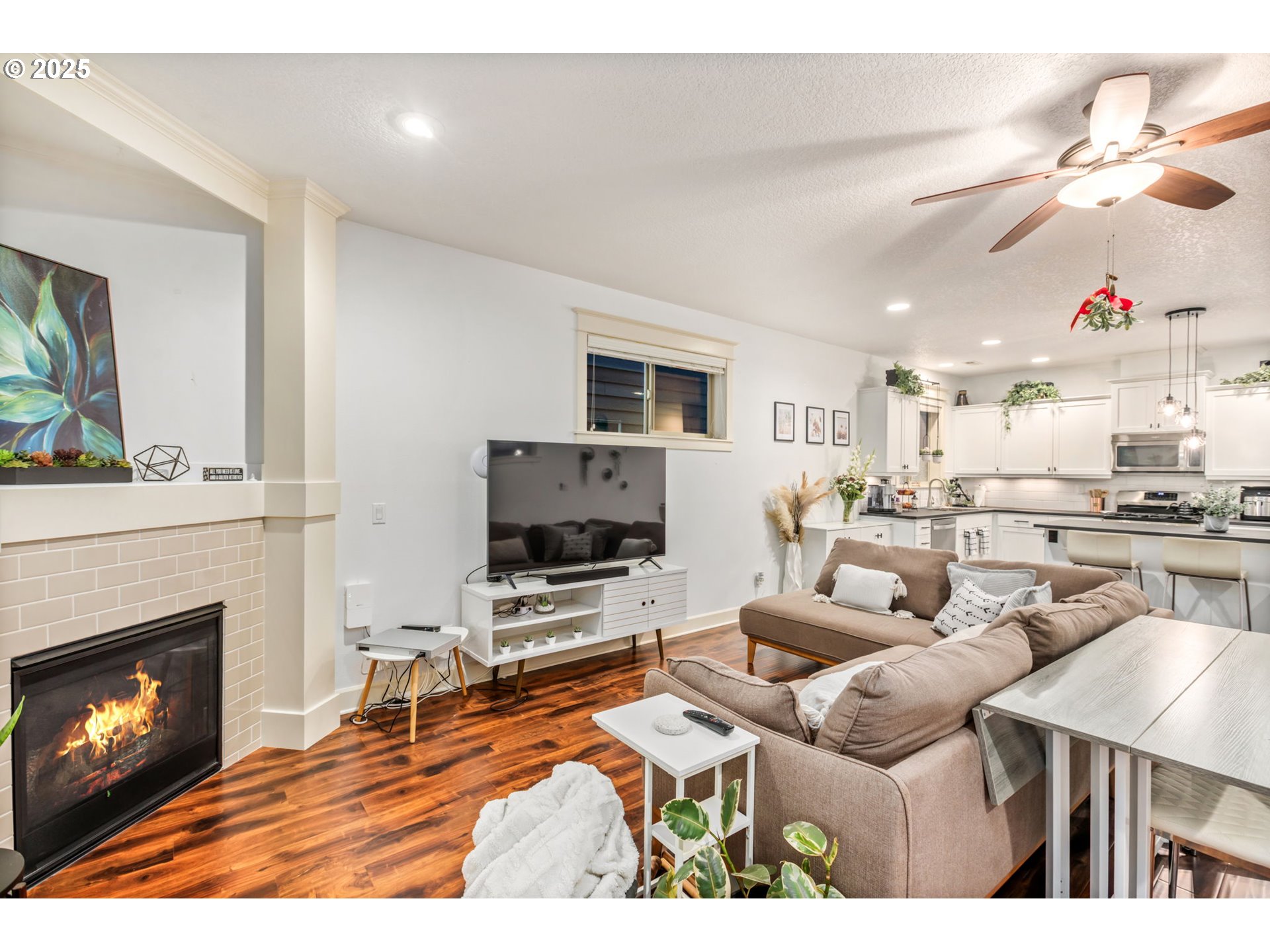 8826 Southwest Spruce Street Portland, OR 97223 - Photo 10 of 34 a living room with furniture a fireplace and a flat screen tv