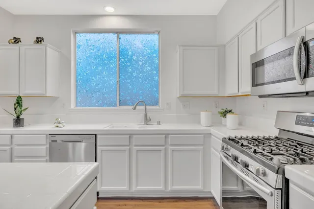 a kitchen with a sink stove and cabinets
