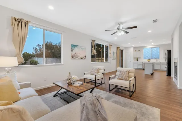 a living room with furniture and wooden floor